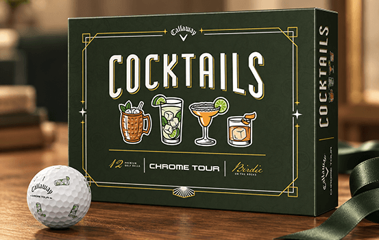 Limited-edition Callaway Chrome Tour Cocktails golf ball box with a cocktail-print golf ball on a wooden tabletop.