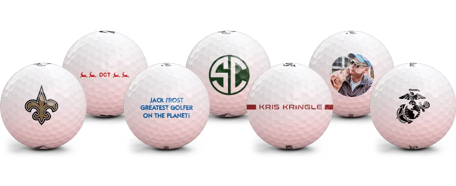Seven golfballs. one with reindeer facing left with the letters DCT, one with the text jack frost greatest golfer on the planet! printing on it, one with a monogram SC, one with two lines on the ball with the name Kris Kringle between them, and one with a photo of a man and a dog, one with a marines insignia